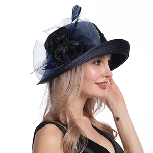 Detail of elegant sun hat with black mesh flowers and delicate feather accents