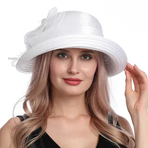 Detailed close-up of white mesh flower and feather accents on an elegant sun hat