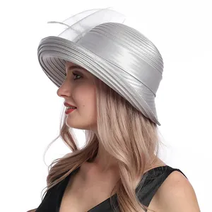 Side view of silver satin church hat with organza flower and layered wavy brim detail