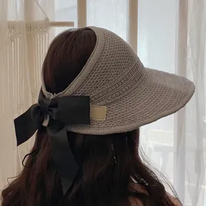 Foldable khaki woven sun hat with a large black silk bow for women's summer vacation