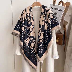 Detail of cashmere-like shawl featuring polka dots, roses, and fringe edges