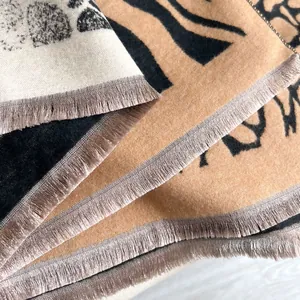 Detailed view of high-density tassels and stylish zebra print on cashmere-like scarf