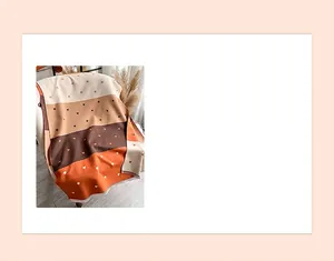 Close-up of heart pattern and striped knit texture on reversible cashmere-feel scarf