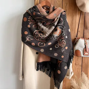 Close-up of ethnic style cashmere scarf featuring traditional floral jacquard and black tassels