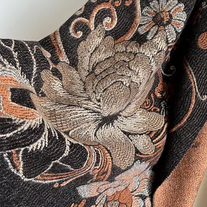 Detailed close-up of ethnic floral jacquard embroidery on black pashmina shawl