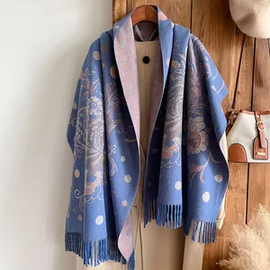 Detailed texture of ethnic floral pattern and tassels on thick blue cashmere-feel shawl