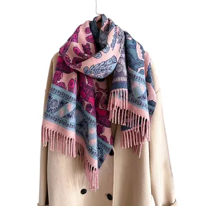 Ethnic plant and horse pattern pashmina shawl with fringes over a beige coat