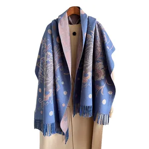Floral cashmere-feel shawl with peony patterns and fringe on a wool coat