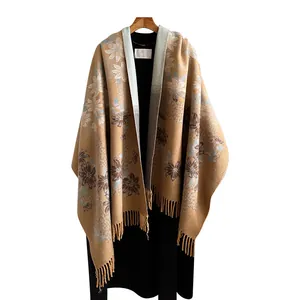 Elegant floral knit poncho wrap in khaki with tassel details and blue cornflower pattern