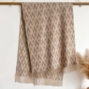 Brown and beige geometric pattern cashmere-like scarf with fringe on wooden hanger