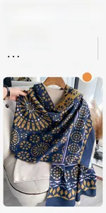Detailed view of dark blue scarf featuring yellow geometric star patterns and fringe