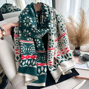 Close-up of winter cashmere shawl with festive snowflake patterns and fringe details