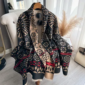 Detail of bohemian wool scarf with vintage patterns and fringes on an armchair