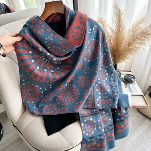 Detailed view of bohemian floral pattern on a soft pashmina shawl with tassel edges
