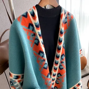 Close-up of bohemian knit poncho featuring ethnic patterns and teal blue wool texture