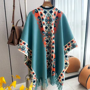 Close-up of ethnic geometric pattern knit poncho with fringe details and soft texture