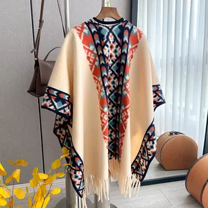 Close-up of geometric knit poncho with colorful ethnic patterns and fringed tassels