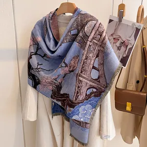 Detail of artistic floral cashmere scarf with blue jacquard pattern and soft fringe edges