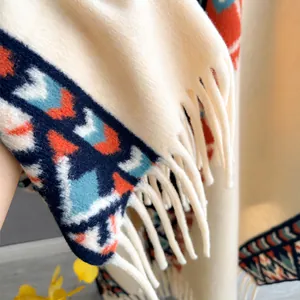 Beige poncho shawl with ethnic geometric patterns and long fringes for women