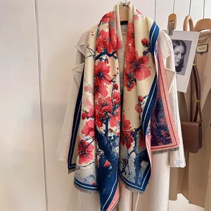 Detail of elegant red plum ink painting on a blue cashmere-feel scarf with tassels