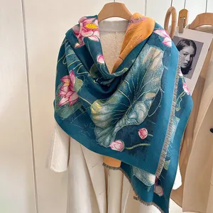 Detail of elegant pashmina scarf with lotus pattern and fine fringe on a wooden hanger
