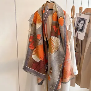 Macro detail of elegant ginkgo leaf pattern and fringe on soft cashmere feel scarf