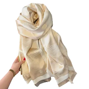 Elegant champagne gold jacquard pashmina shawl with tassel trim and silk texture