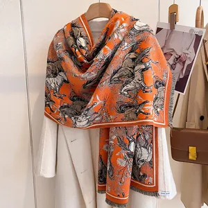 Close-up of elegant horse print scarf with soft gray fringe and handmade label detail