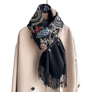 Ethno-Stickschal in Schwarz mit Blumenmuster und Fransen auf beigem Mantel