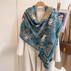 Detail of teal cashmere-feel scarf with equestrian horse print and fringe tassels