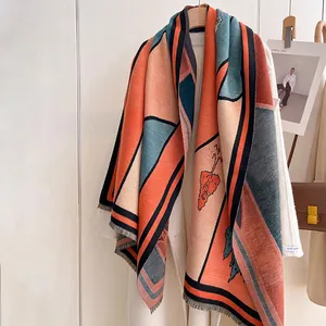 Detail shot of winter cashmere-like scarf with landscape pattern and fringe tassels