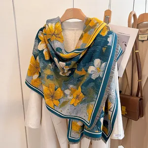 Elegant floral cashmere-like winter scarf with blue and yellow patterns and tassels