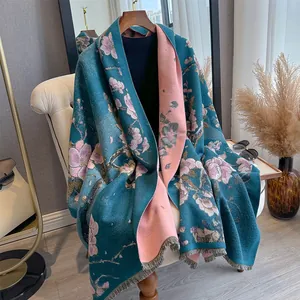 Detail of floral cashmere-like shawl with tassels and elegant double-sided print
