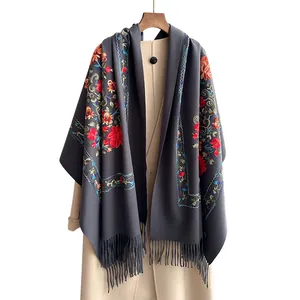 Ethnic style dark grey floral embroidery scarf with tassels on display