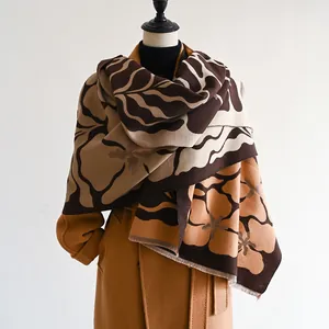 Winter floral cashmere shawl in brown and camel tones styled on a wool coat