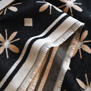 Detail of cashmere-like scarf showing sun flower patterns and refined fringe edges