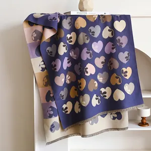 Detail of the double-sided heart floral print and fringe tassels on the purple scarf