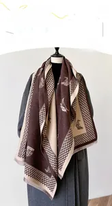 Close-up of houndstooth scarf with sailboat print, cashmere texture and fringe detail