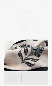 Close-up of floral cashmere feel scarf featuring warm, abrasion-resistant woven texture
