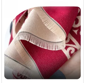 Close-up of knit cashmere scarf fringes showing high-quality texture and red beige pattern