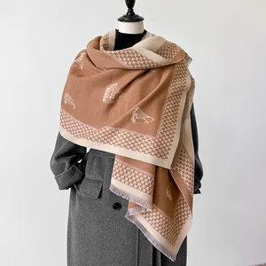 Close-up of winter cashmere-feel scarf with sailboat pattern and elegant tassels