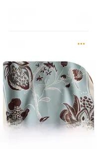 Macro shot of grey-blue floral pomegranate pattern on soft polyester shawl fabric