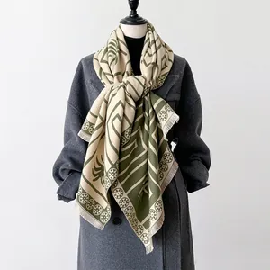 Detail of green and beige check scarf showing tassel edges and soft knit texture