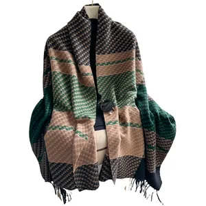 Plaid cashmere-like scarf with green and khaki patterns and fringe on mannequin