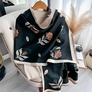 Detailed close-up of floral print cashmere-feel scarf with elegant fringe and patterns