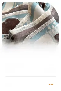 Detail of pomegranates floral scarf showing white short fringe edge and woven texture