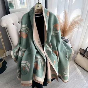 Detail of dark green cashmere-feel shawl with vintage floral print and tassel edges