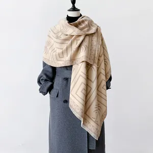 Detail of cashmere feel scarf with coconut tree patterns and soft fringe trim