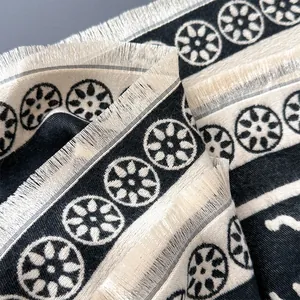 Elegant checkered winter shawl in monochrome tones with fringe detail and soft texture