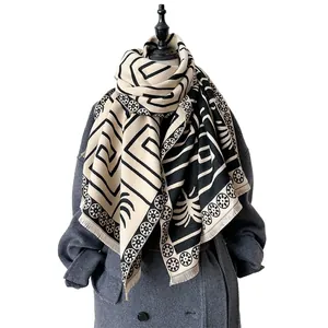 Classic beige and black cashmere-feel shawl with geometric patterns and fringe detail